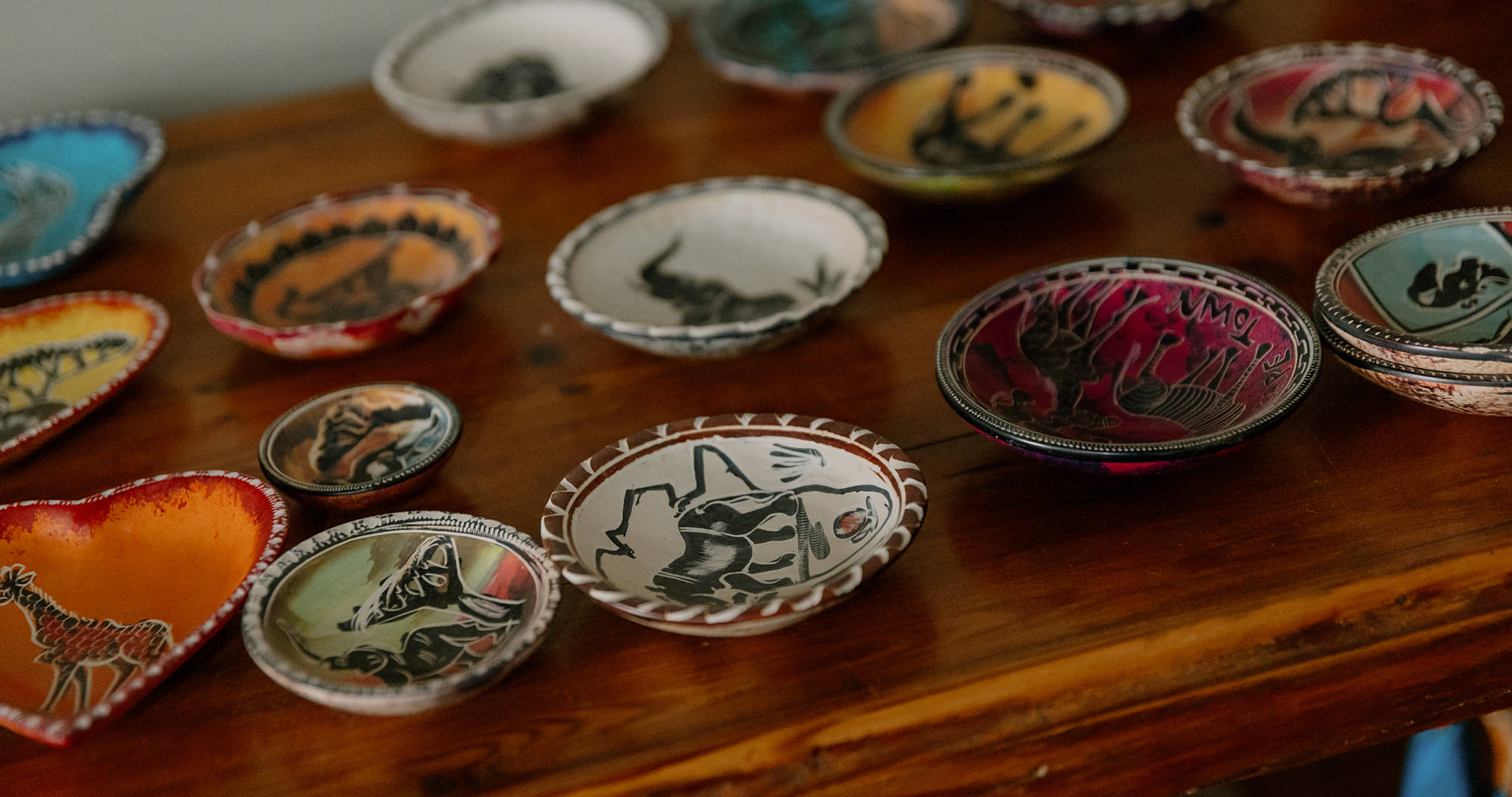 Bowls with bushman art drawings on inside on table